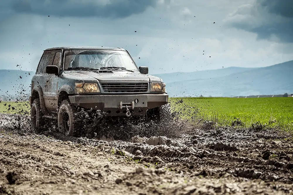 offroad vehicle driving in mud