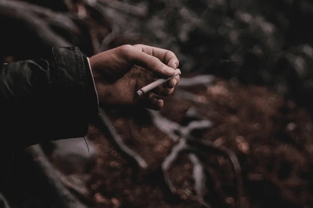 cigarette smoking outside in the woods