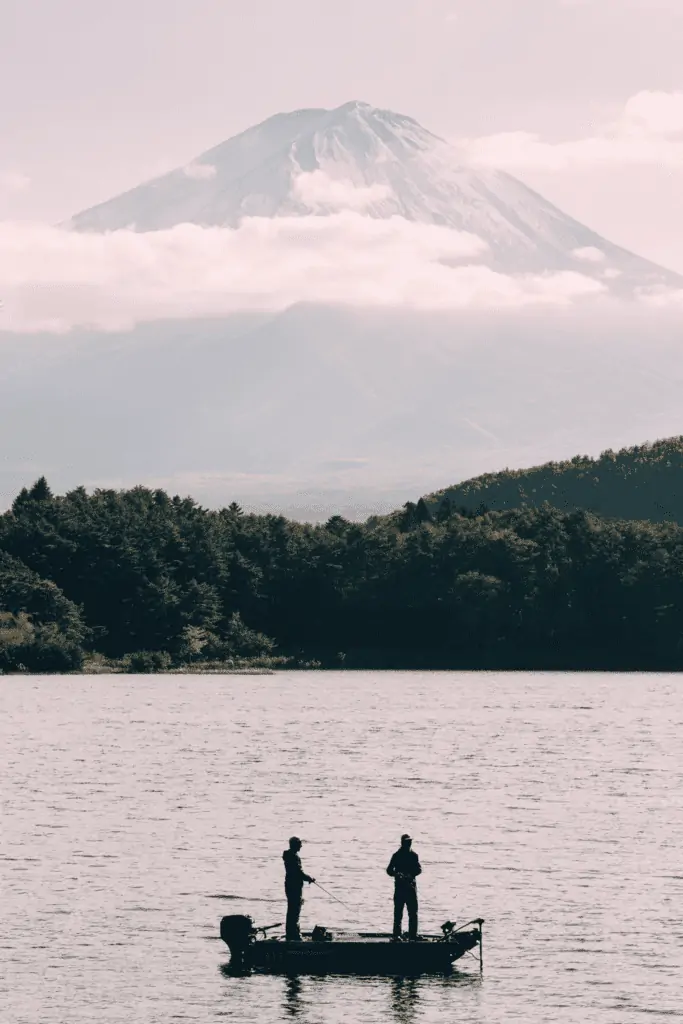 two friends fishing on a boat