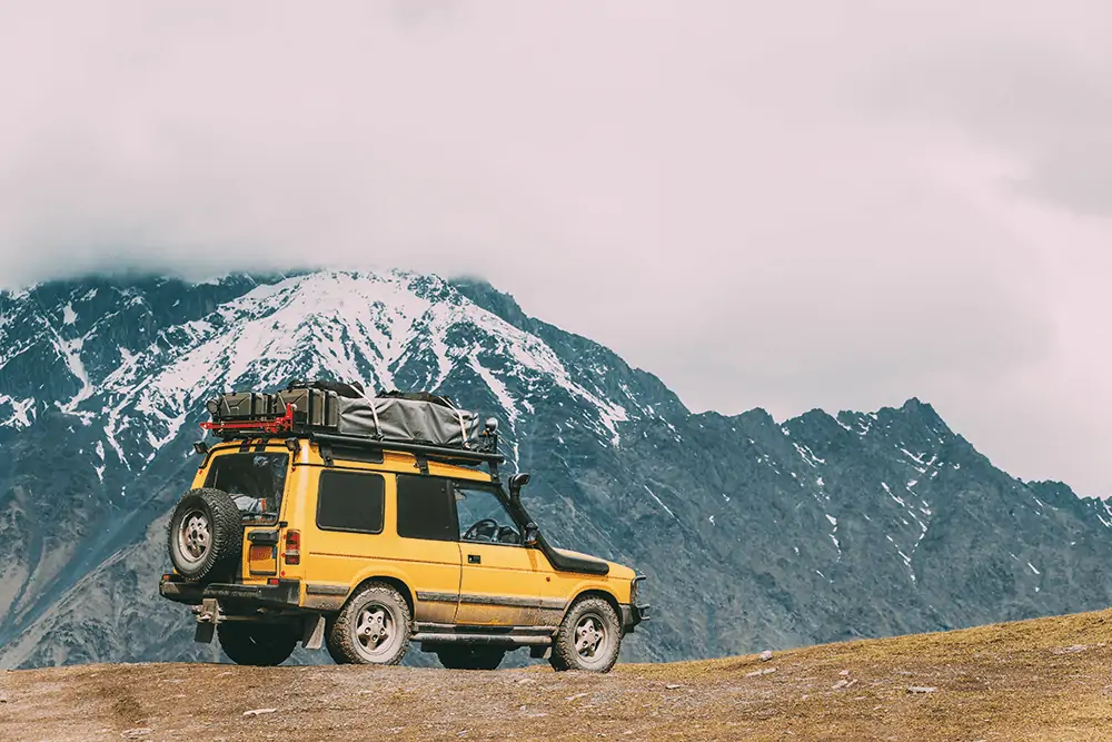 yellow suv on hilltop