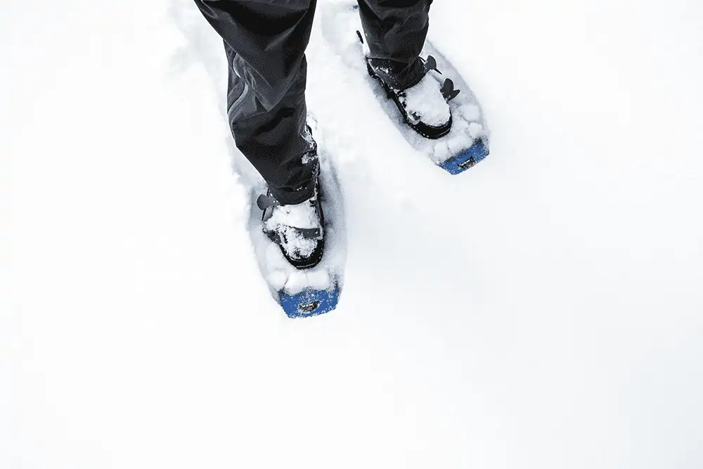 hiker with snowshoes on